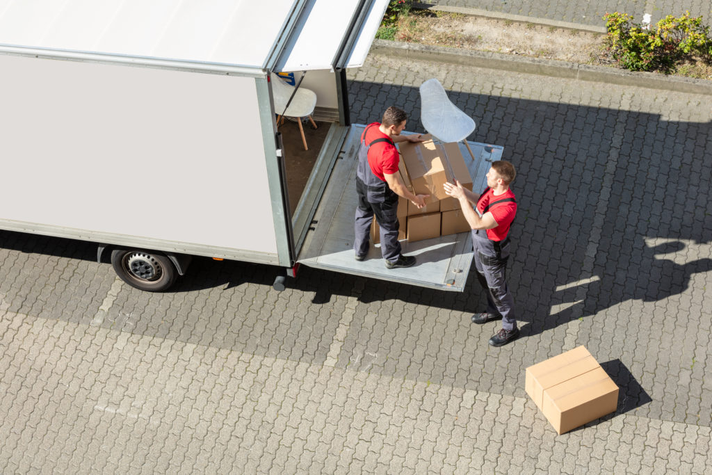 men loading stuff on the truck.