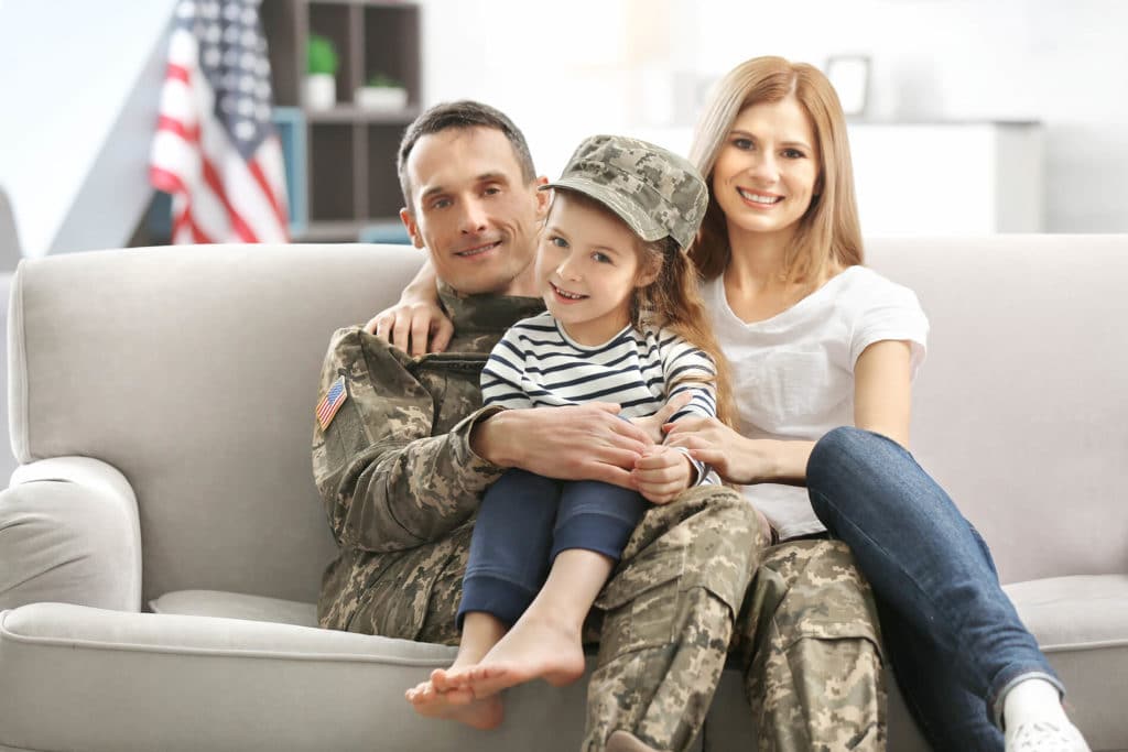 Man,woman and a child sitting on a couch