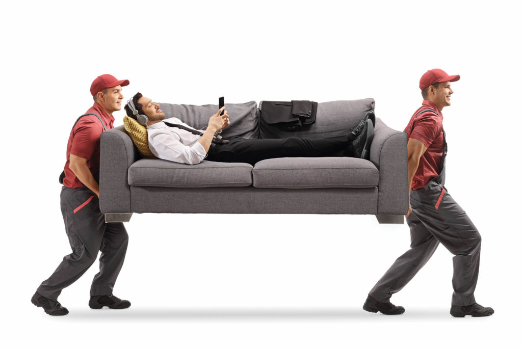 Men carrying a man on a couch.
