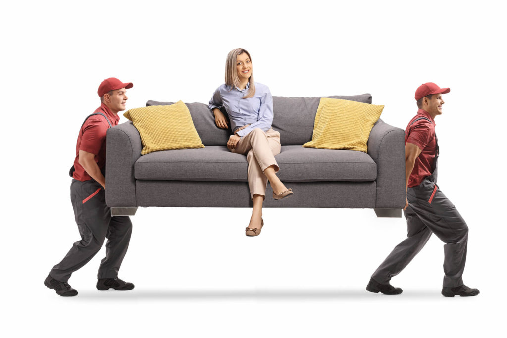 Men carrying a woman on the sofa