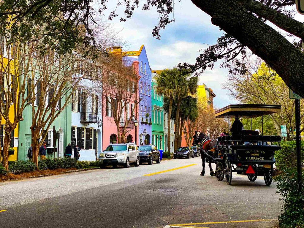 people riding on carriage on road in Charleston, South Carolina