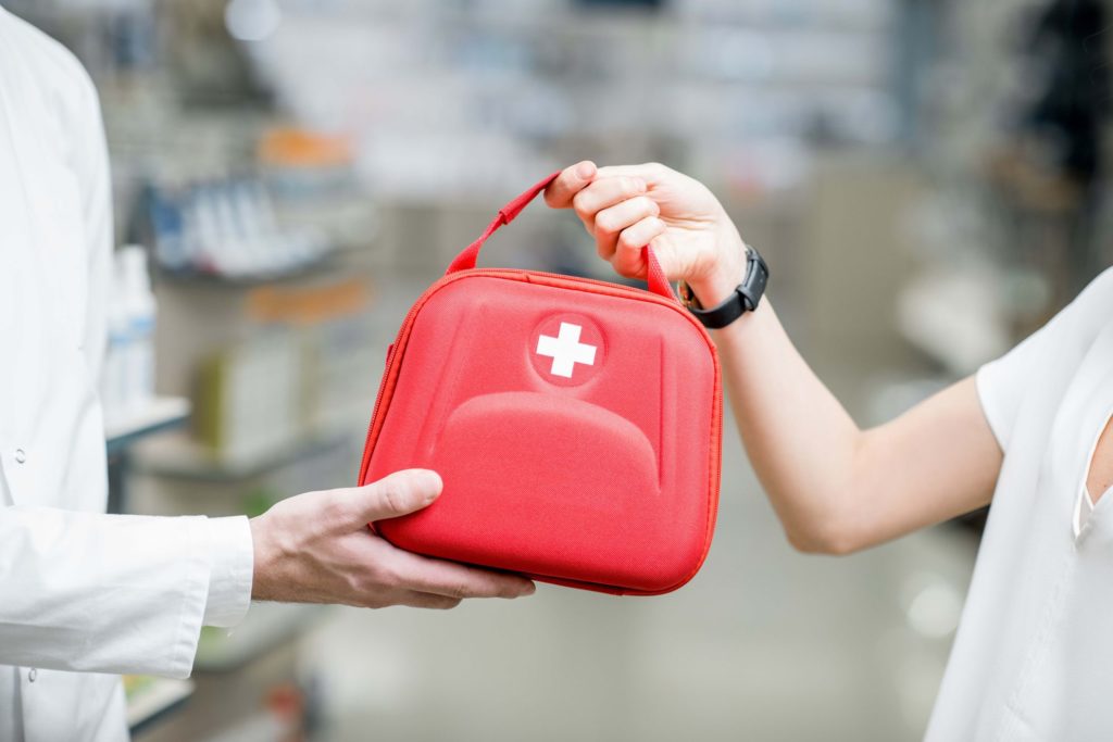 person handing out first aid kit