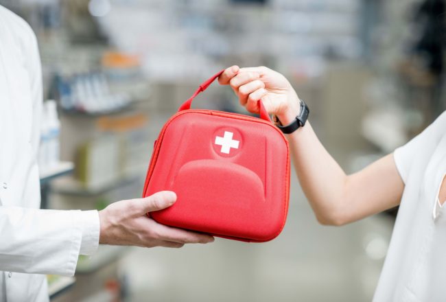 person handing out first aid kit (1)