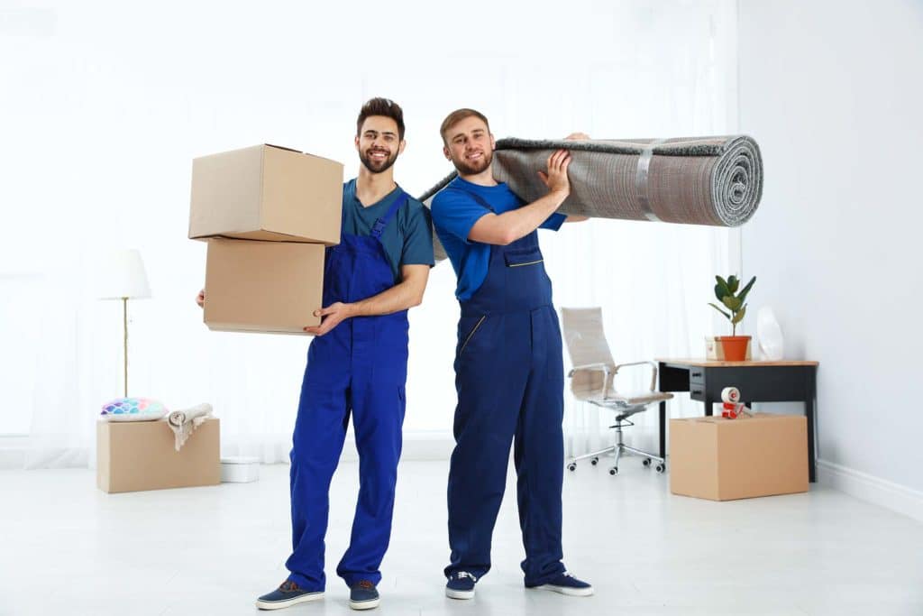 Two state-to-state movers carrying boxes and a carpet