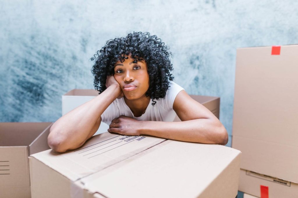 woman leaning on a moving box