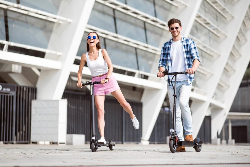Couple driving electric scooters