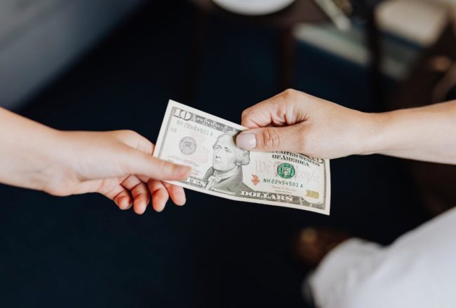 hands-holding-a-10-dollar-bill tips
