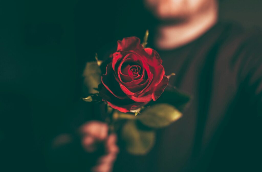 A man holding a  flower