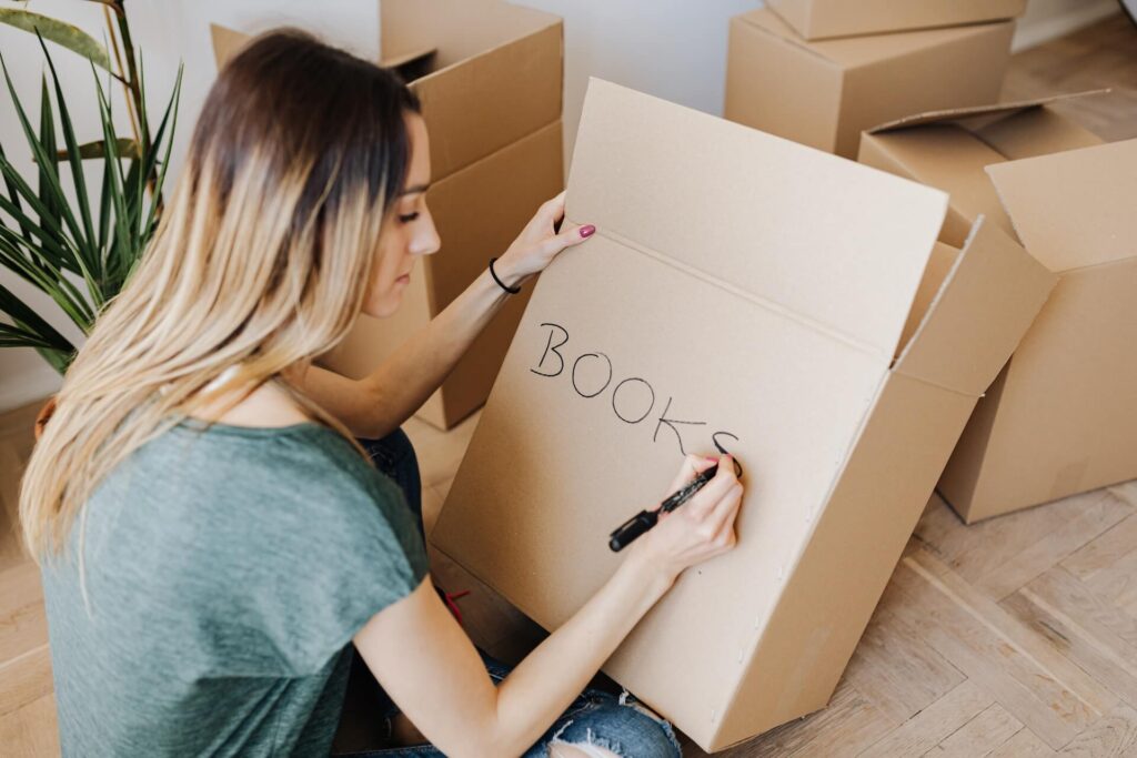 A woman preparing boxes for packing