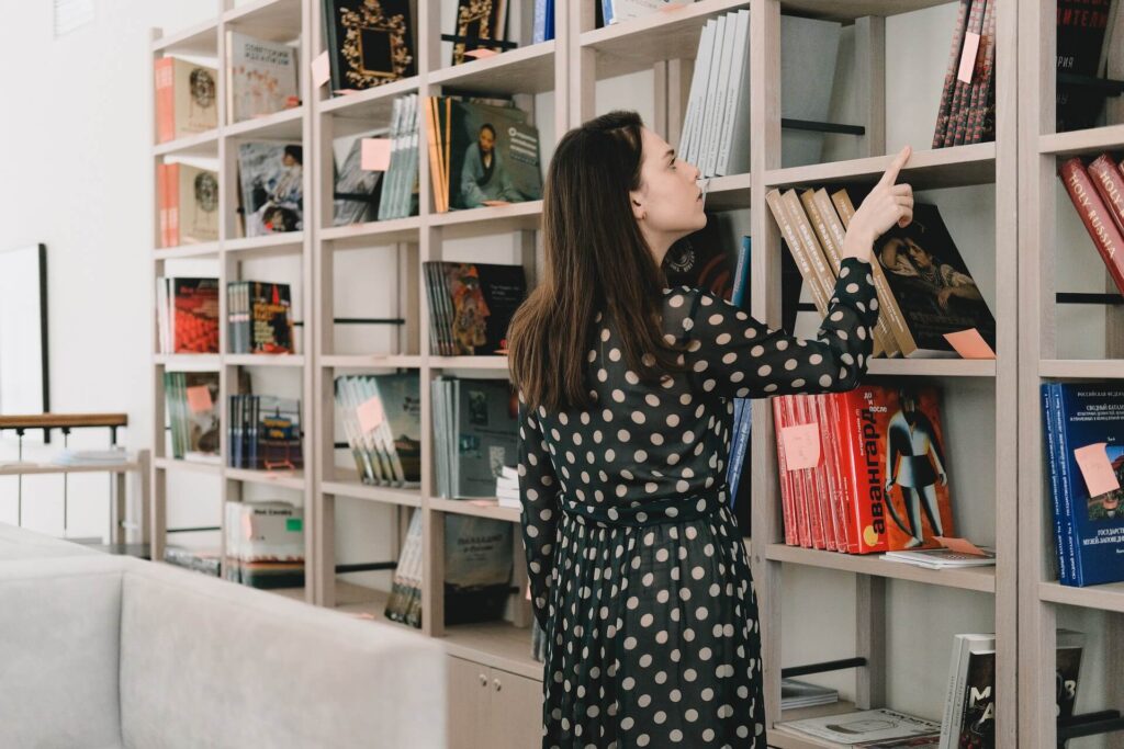 young woman choosing books before a move