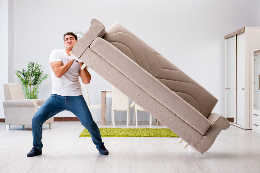 A man moving a couch