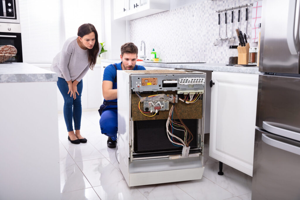 A man connecting a dishwasher