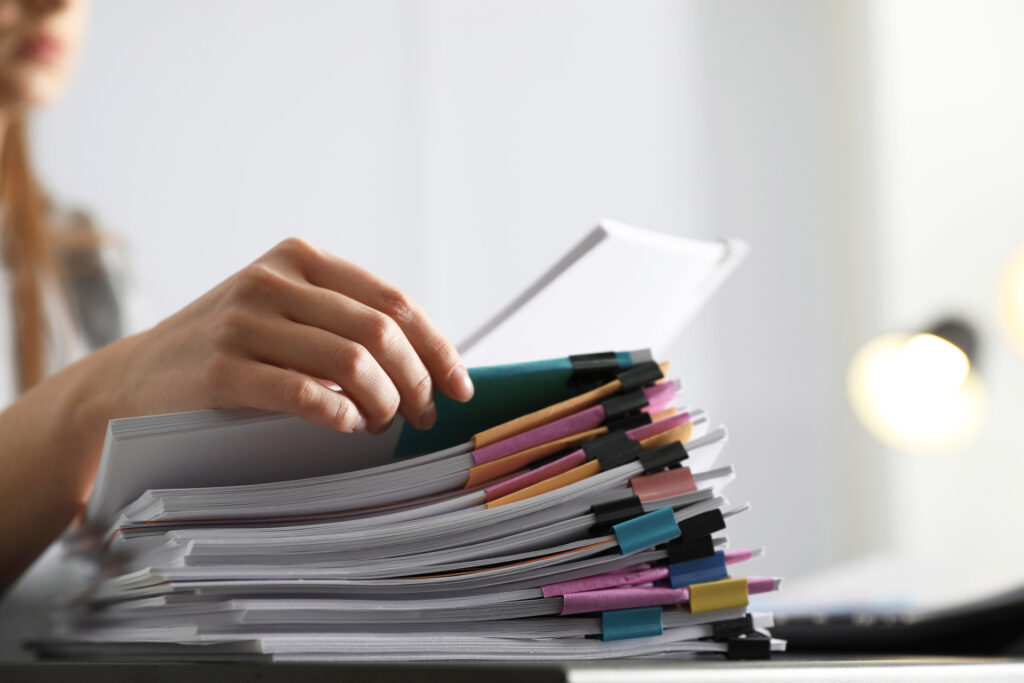 Person going through a stack of documents