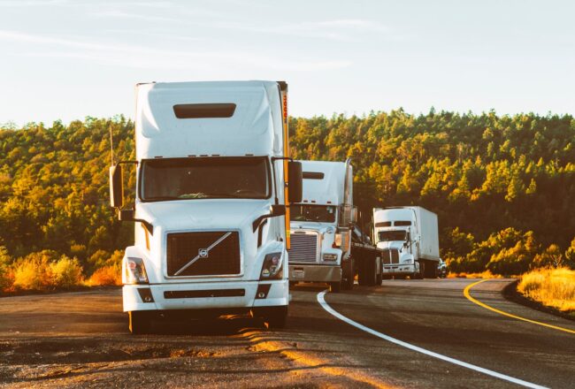 Three relocation trucks on the road