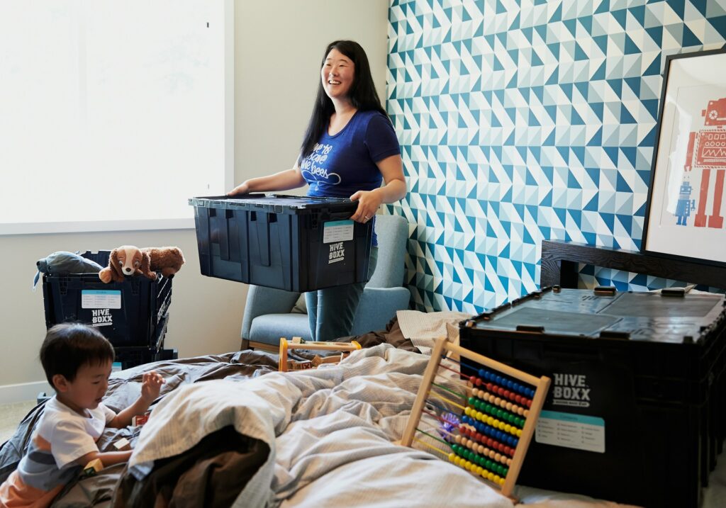 A woman packing things in plastic containers for interstate moving
